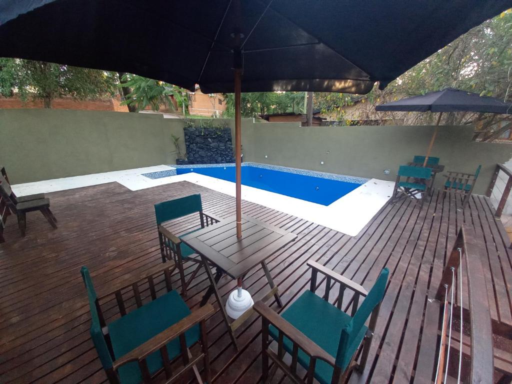 a patio with a table and chairs and a pool at Amambay Apart &Suites in Eldorado
