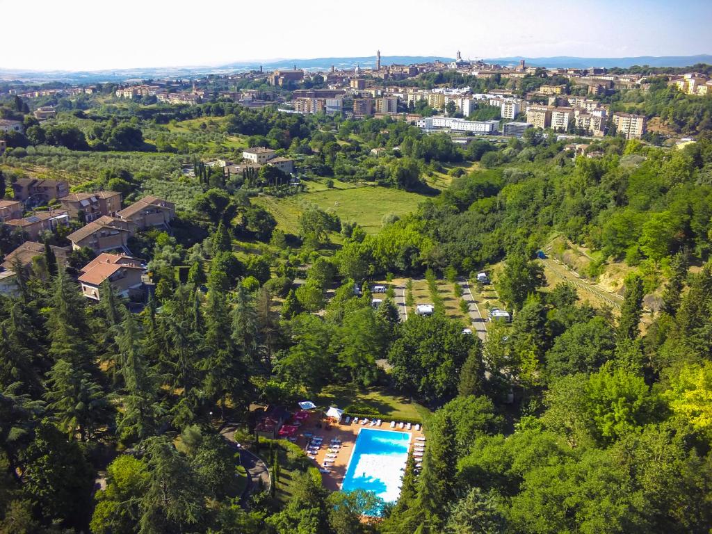 an aerial view of a resort with a pool and trees at Camping Siena Colleverde in Siena
