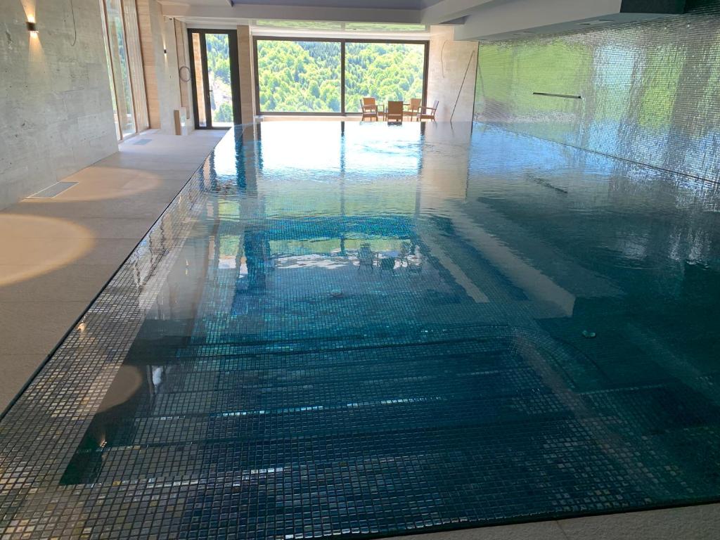 a swimming pool with water in the middle of it at Apart1305zoned2 in Kopaonik