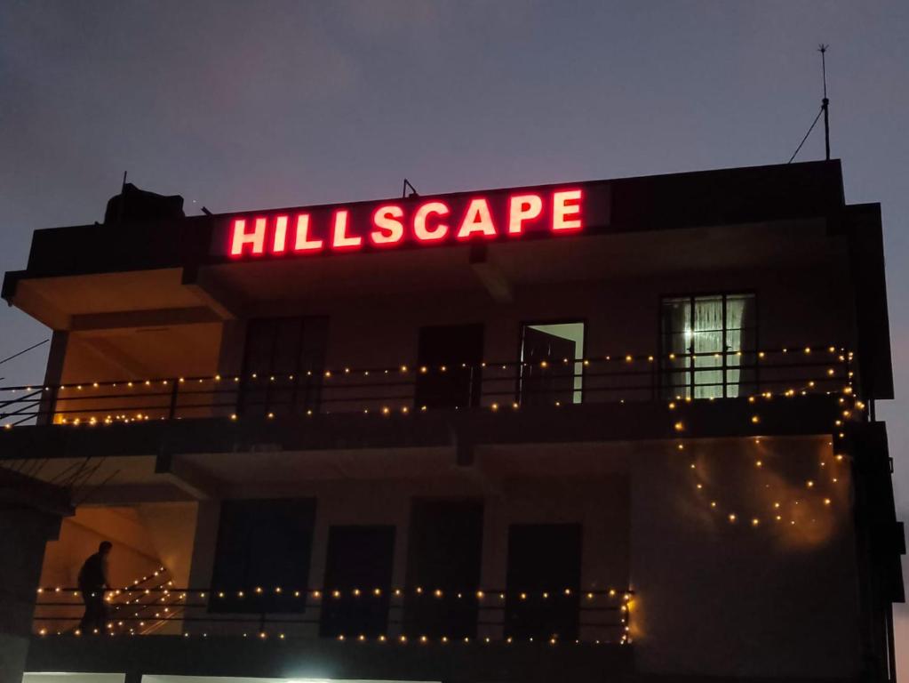 a sign on top of a building with lights at HILLSCAPE in Cherrapunji