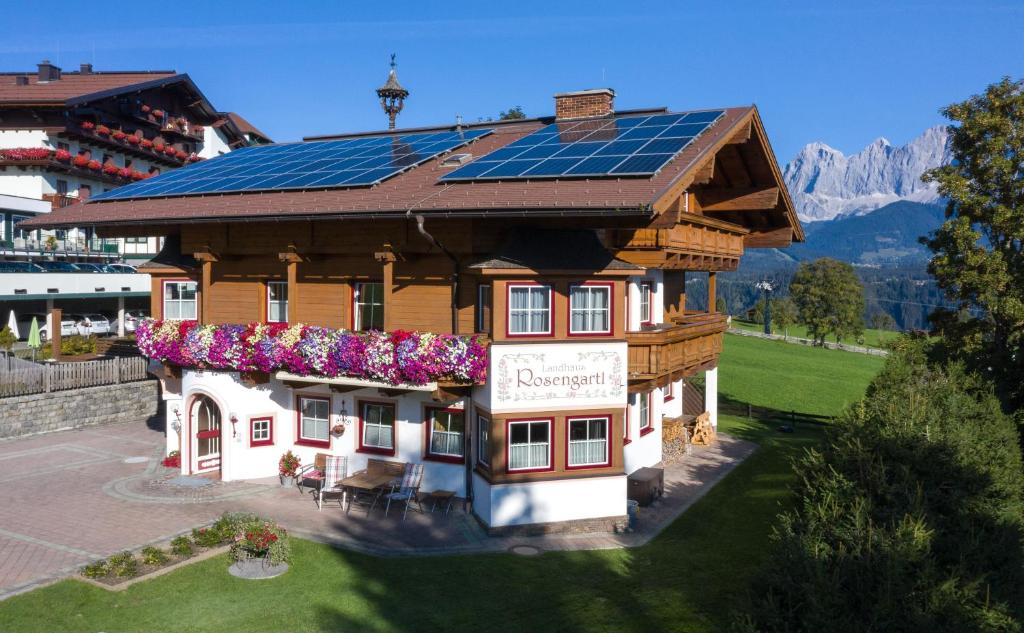 a house with a solar roof with flowers on it at Landhaus Rosengartl in Schladming