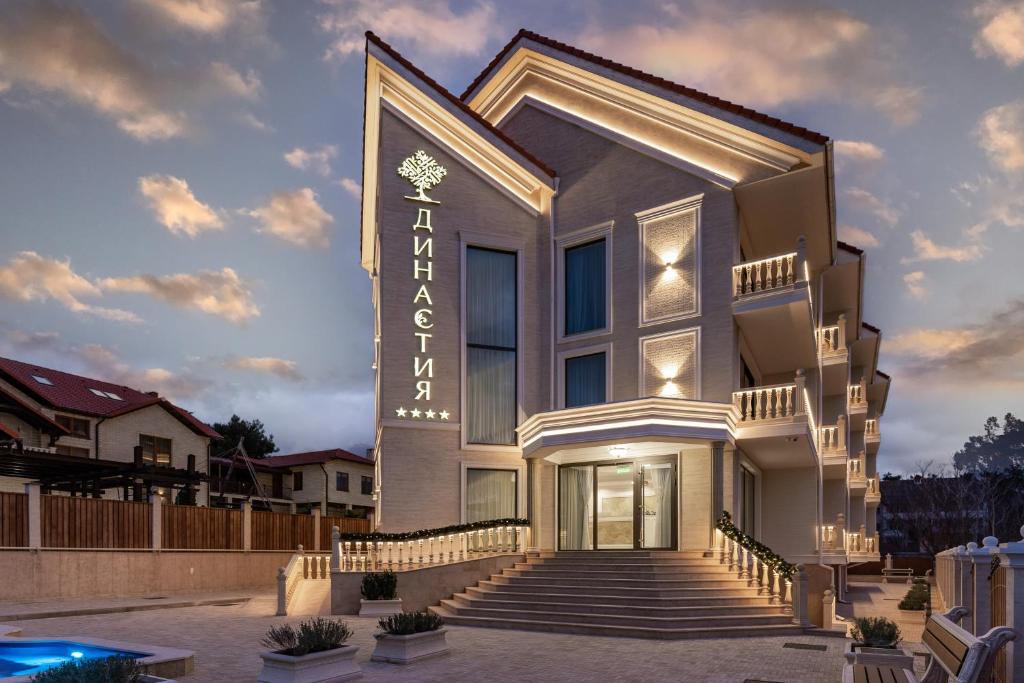 a building with stairs and a sign on it at Dynasty Hotel in Gelendzhik