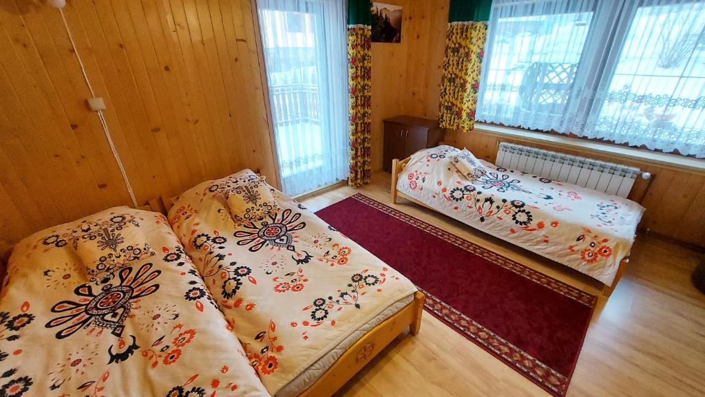 Posteľ alebo postele v izbe v ubytovaní Willa Stachoniówka