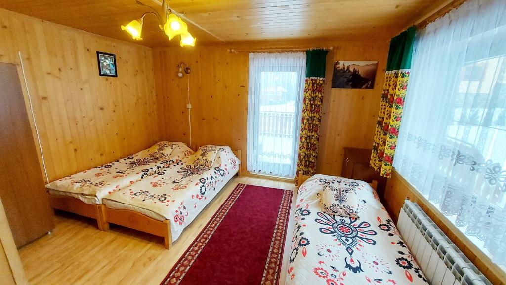 Posteľ alebo postele v izbe v ubytovaní Willa Stachoniówka