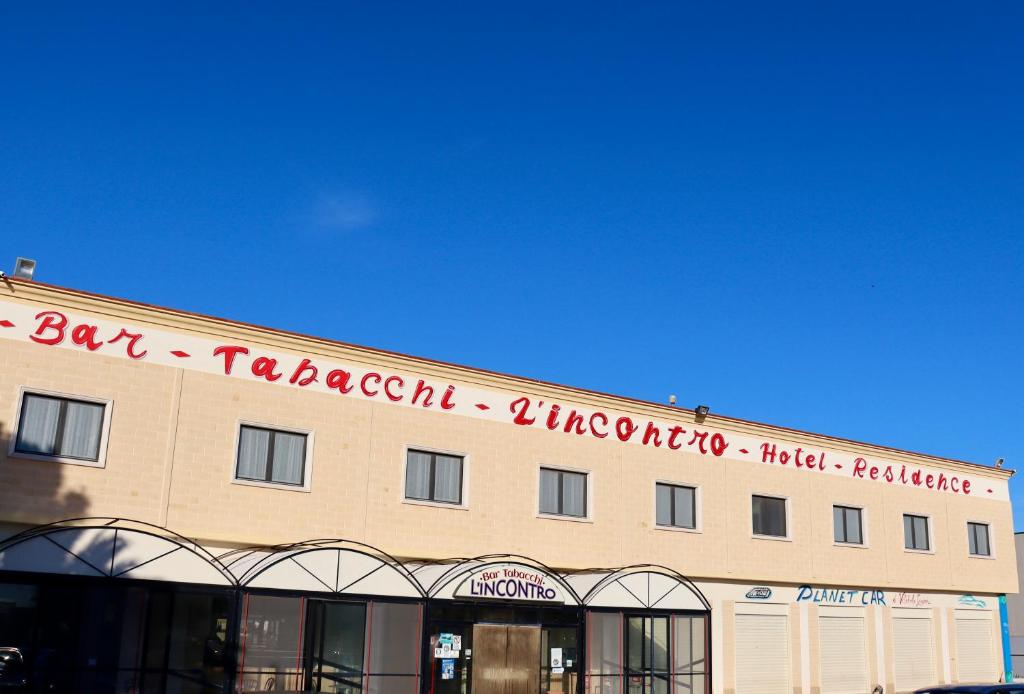 a building with a sign on the top of it at L'incontro in Trinitapoli