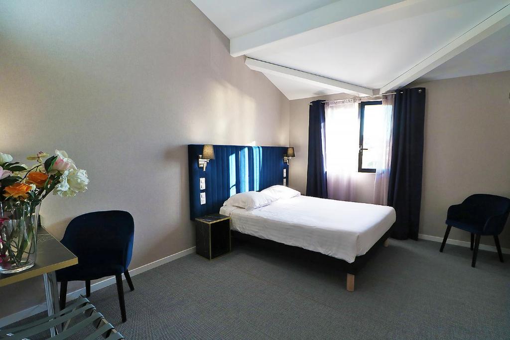 Postel nebo postele na pokoji v ubytování Hôtel Napoléon