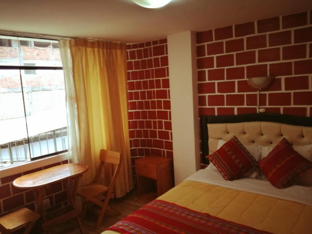 Postel nebo postele na pokoji v ubytování Hostal Encanto Machupicchu