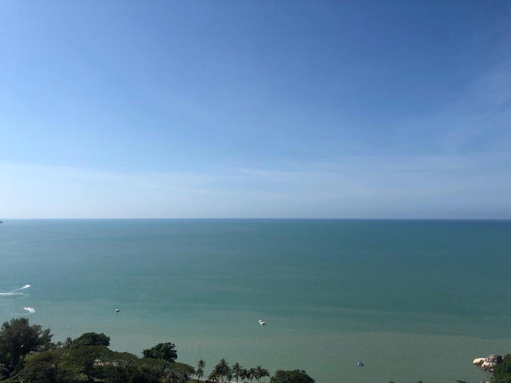 a view of the ocean from the top of a hill at Beach Resort Home Stay 25 Batu Ferringhi Penang in Batu Ferringhi
