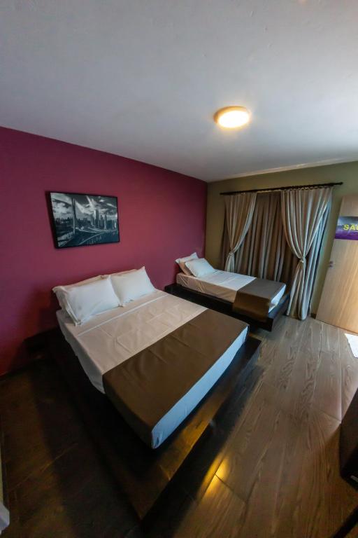 Cama ou camas em um quarto em Bonabrigo Hostel & Suítes