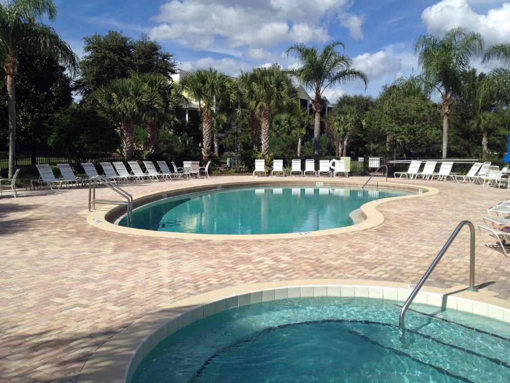 a large swimming pool with chairs at Bahama Bay, Grand Bahama spacious 3-bedroom Penthouse near Disney in Kissimmee