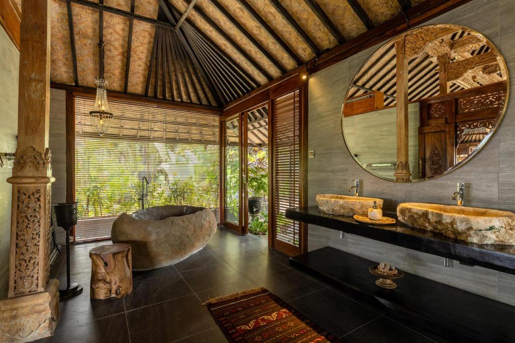 a large room with a large bed and a large window at Samanvaya Luxury Resort & Spa - Adults Only in Sidemen