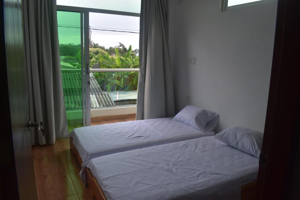 a bedroom with a bed and a large window at Apto Casa Zeus Arboletes in Arboletes