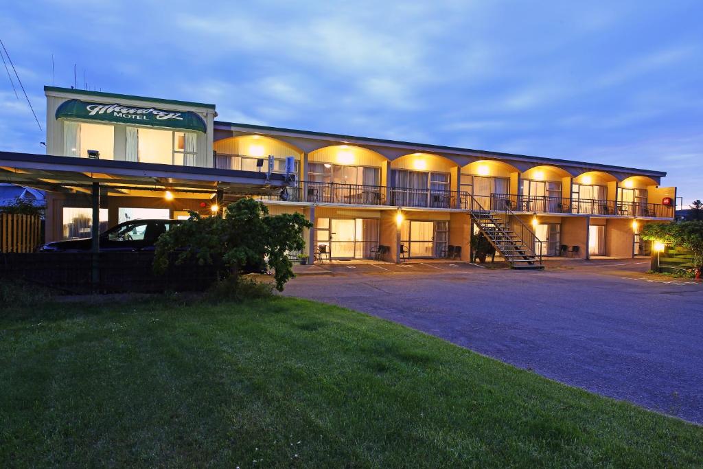 a building with a car parked in front of it at 289 Midway Motel in Oamaru