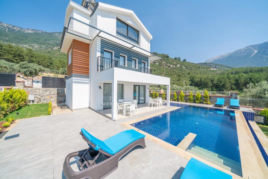 a villa with a swimming pool and a house at SAKURA VILLA in Fethiye