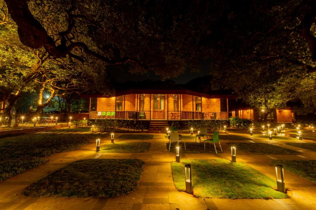 a building with lights in a courtyard at night at R R Heritage Resort Pure Vegetarian in Mahabaleshwar