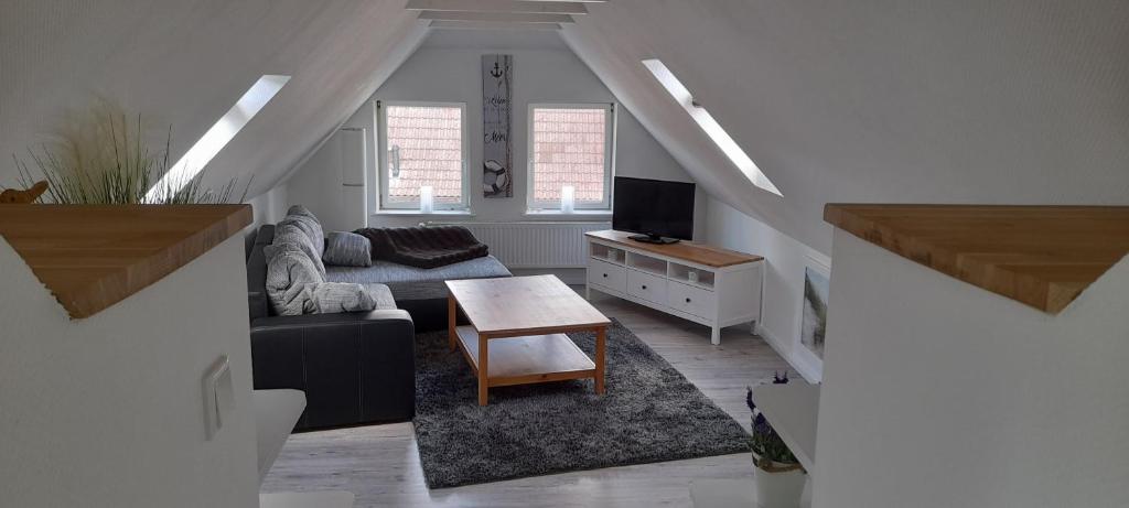 a living room with a couch and a table at Haus Groth - Wohnung Heinke - Schupp1 in Tönning