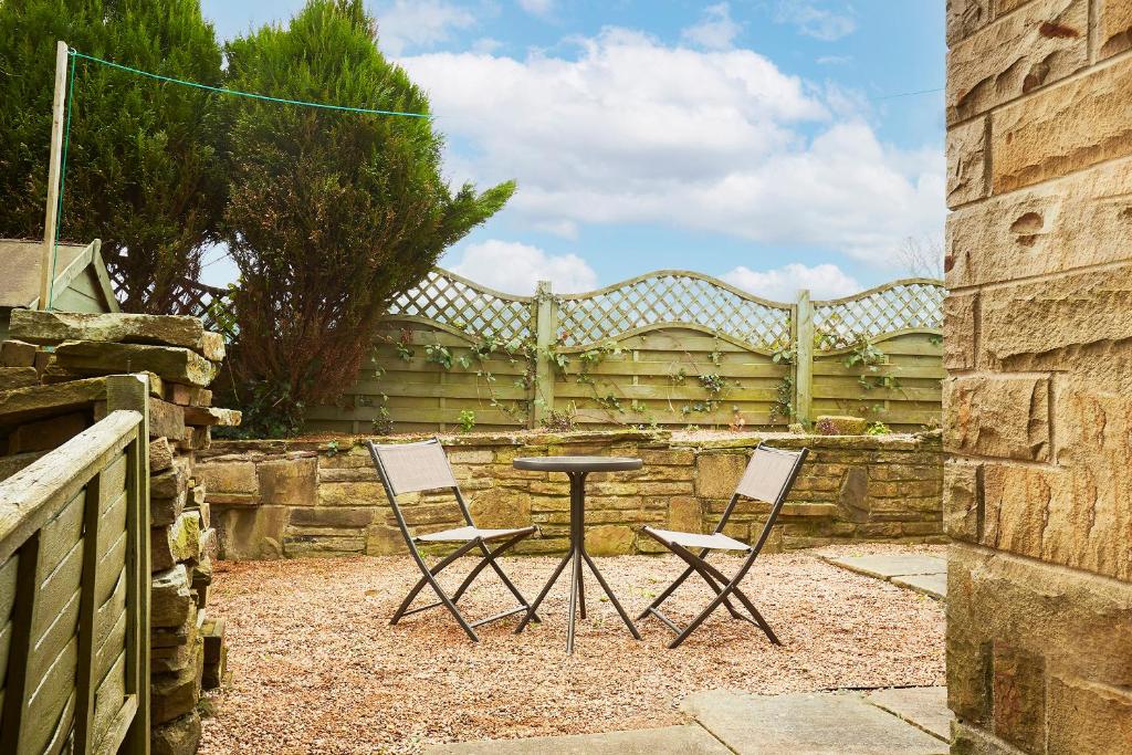 two chairs and a table in front of a fence at Blossomgate in Halifax