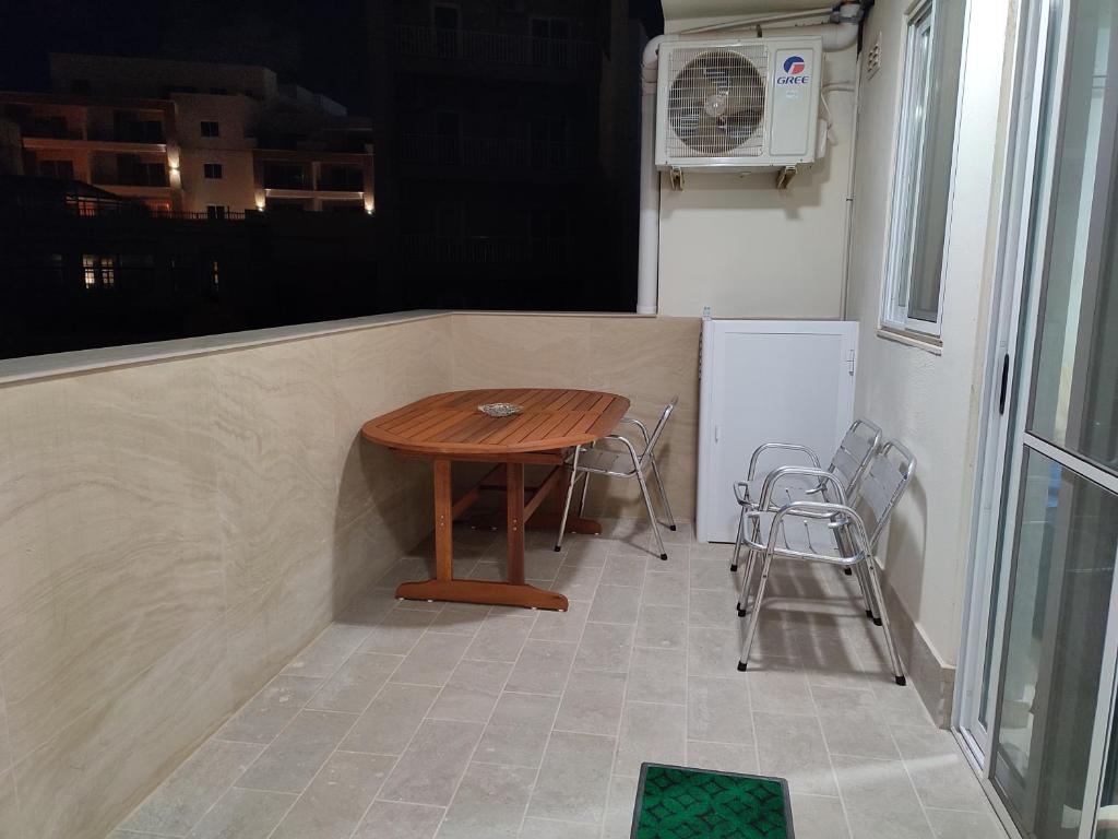 a small table in the back of a tiny house at One Bed Room Apartment with terrace in Marsaskala
