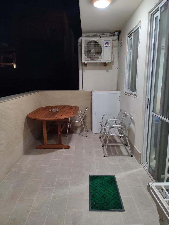 a small room with a table and chairs and a fan at One Bed Room Apartment with terrace in Marsaskala