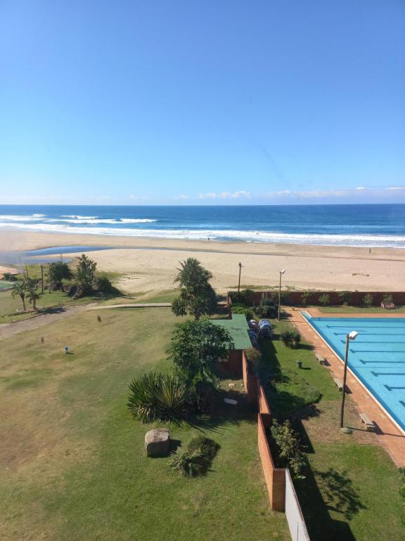 a view of a swimming pool and the beach at Margate Boulevard Beachfront Apartment in Margate