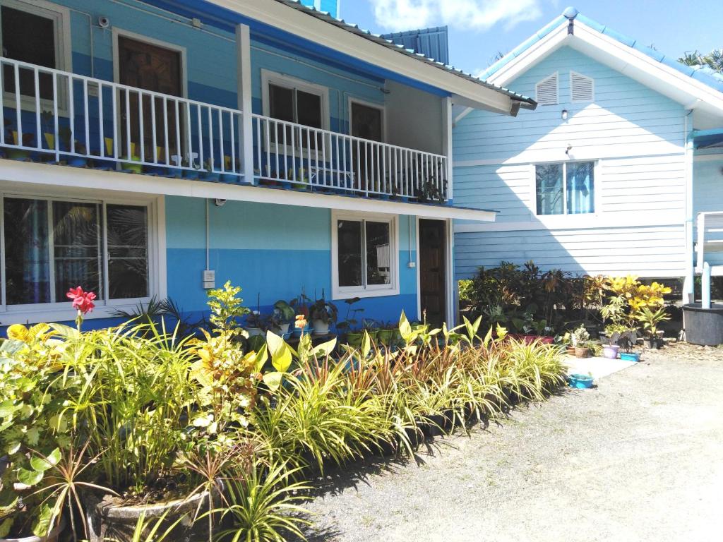 a blue house with plants in front of it at Krasom Homestay in Phang-nga