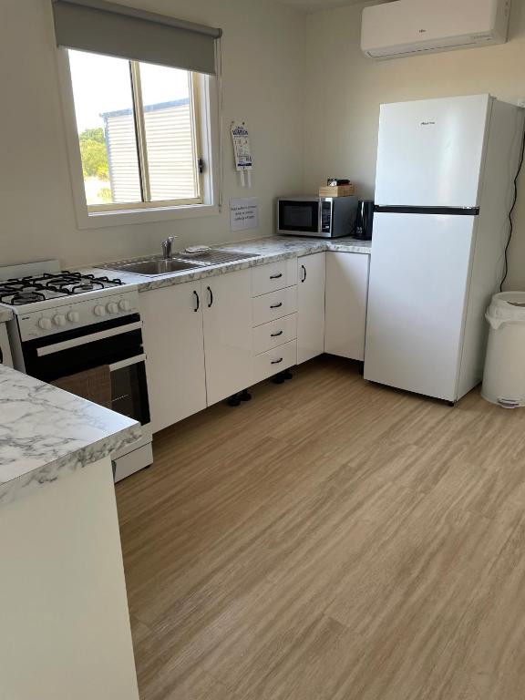een keuken met witte apparatuur en een witte koelkast bij Portland Bay Lodge, 2 Bedroom Apartments in Portland
