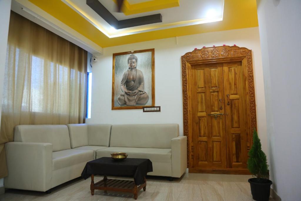 a living room with a couch and a door at Harsha Haritha Residency in Cuddalore