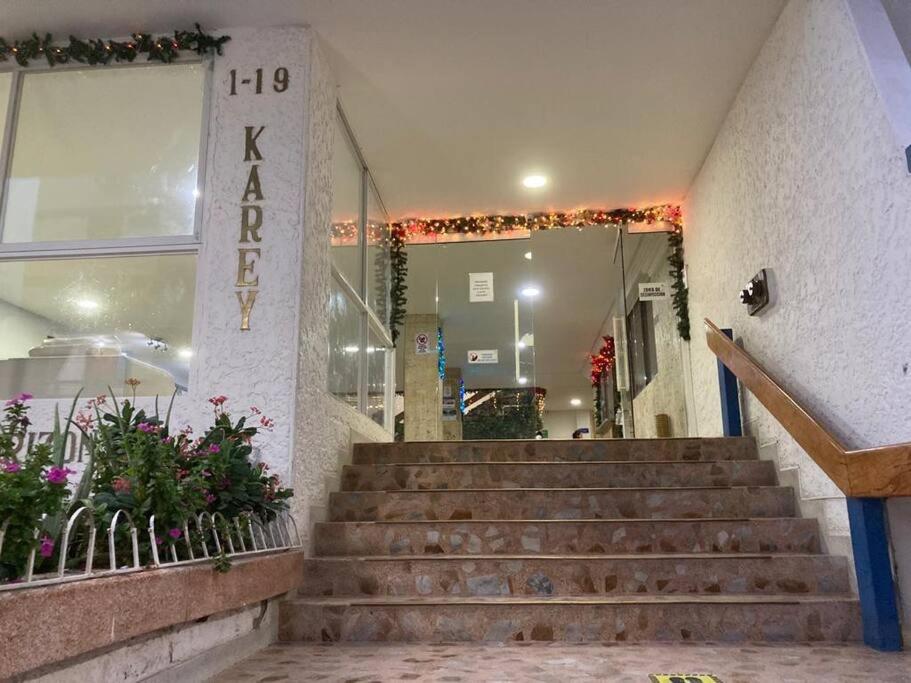 a staircase in a building with a sign that reads karma at Apartamento Karey 203 Rodadero, Santa Marta in Santa Marta