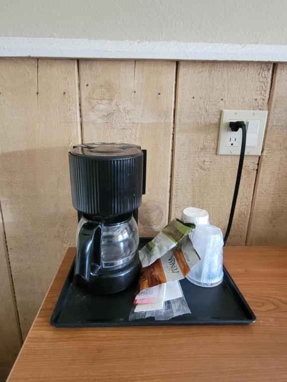a coffee maker sitting on top of a table at Townhouse Motel in Bishop