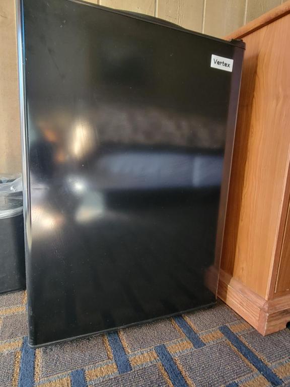 a black door of a refrigerator in a room at Townhouse Motel in Bishop
