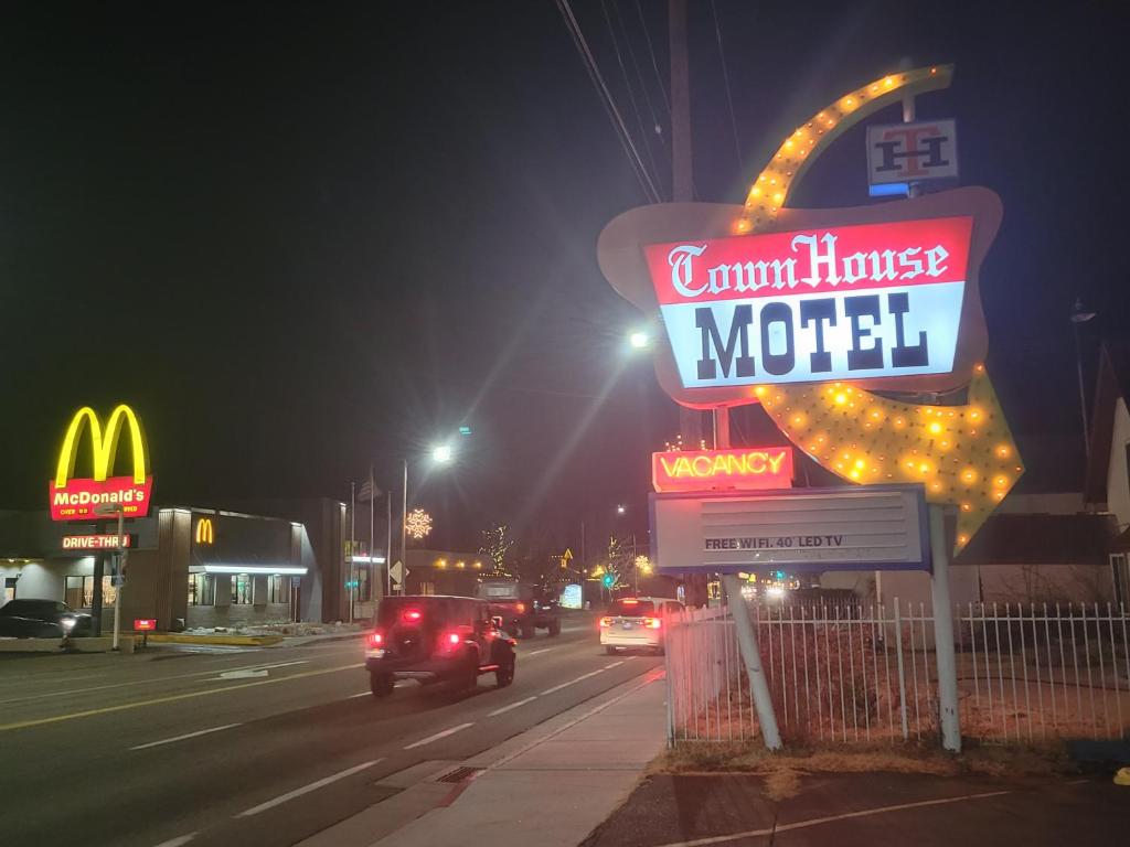 a sign for a motel on a street at night at Townhouse Motel in Bishop