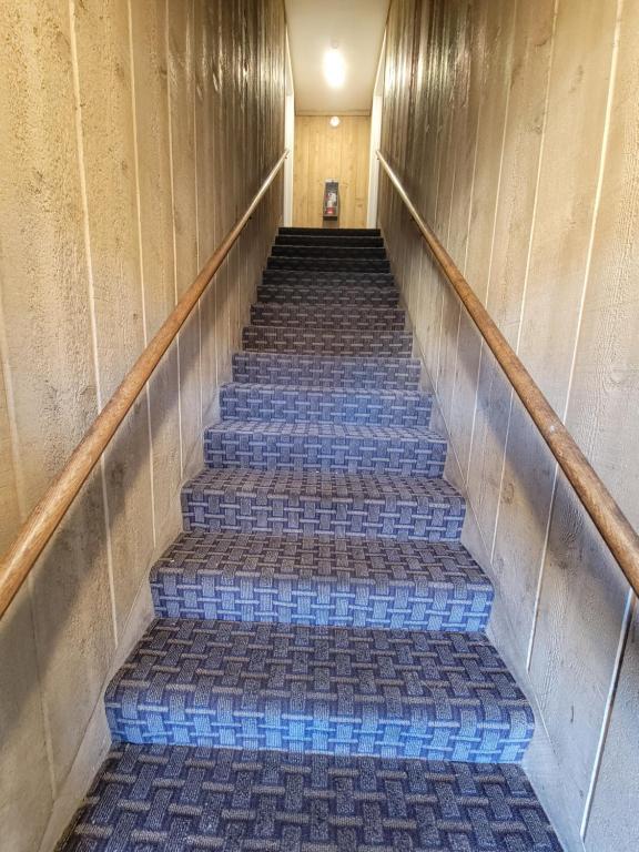a flight of stairs in a building with blue tiles at Townhouse Motel in Bishop