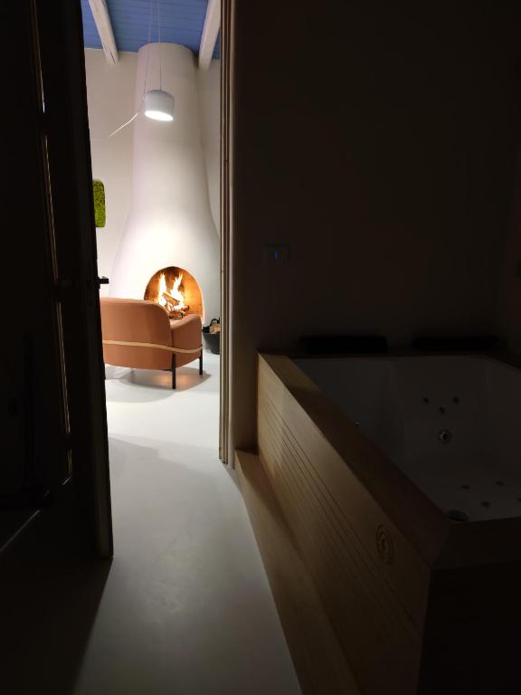 a living room with a couch and a fire place at Casa Mediterranea Jacuzzi riscaldata con Caminetto in Specchiolla
