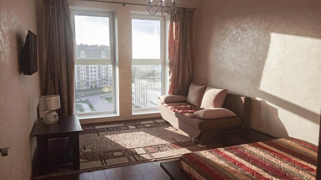 ein Wohnzimmer mit einem Sofa und einem großen Fenster in der Unterkunft Apartent Turgeneva 10G in Selenogradsk