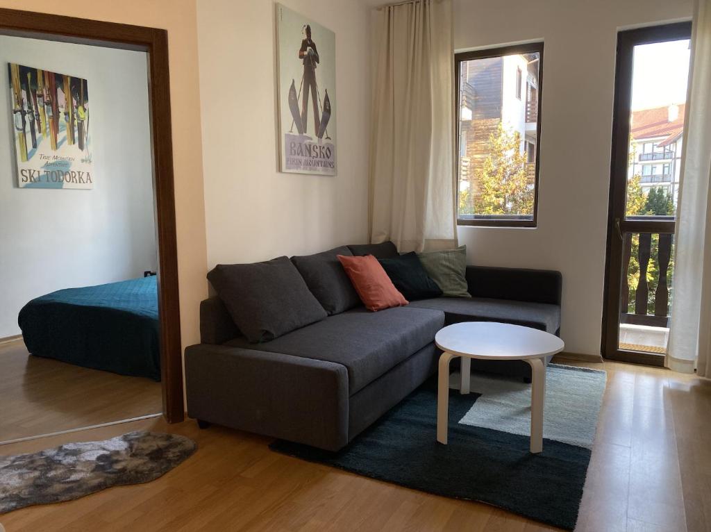 a living room with a couch and a table at 2 BR apartment next to Gondola Ski Lift in Bansko