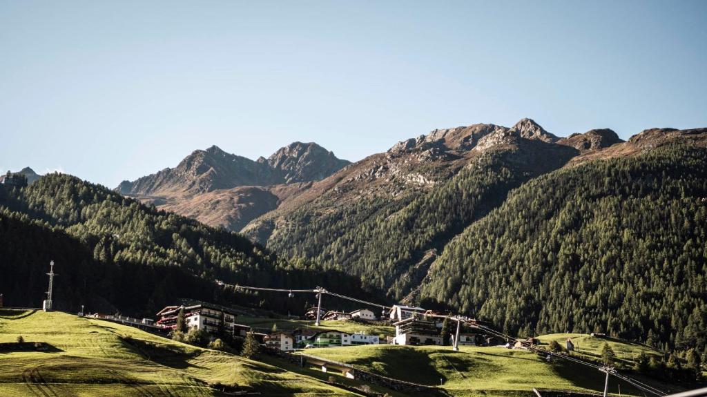 a train on a track in front of a mountain at die berge lifestyle-hotel Sölden in Sölden