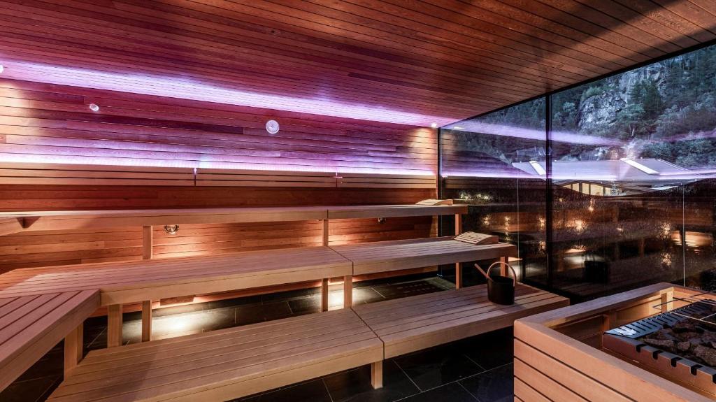 a sauna with wooden benches in a room at die berge lifestyle-hotel Sölden in Sölden