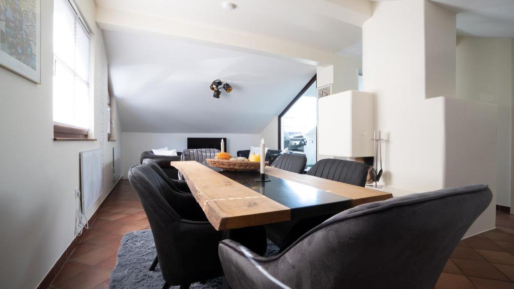 a dining room with a table and black chairs at RM-Apartments in Innsbruck