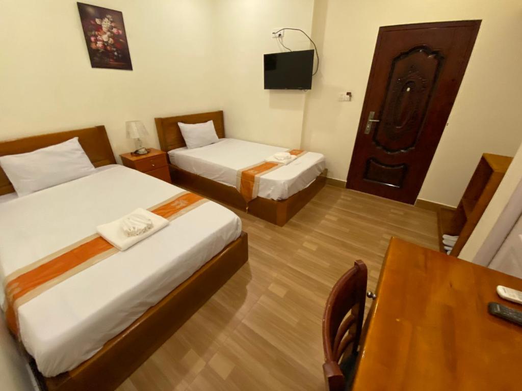 Postel nebo postele na pokoji v ubytování Phnom Penh Le Vincent Hotel