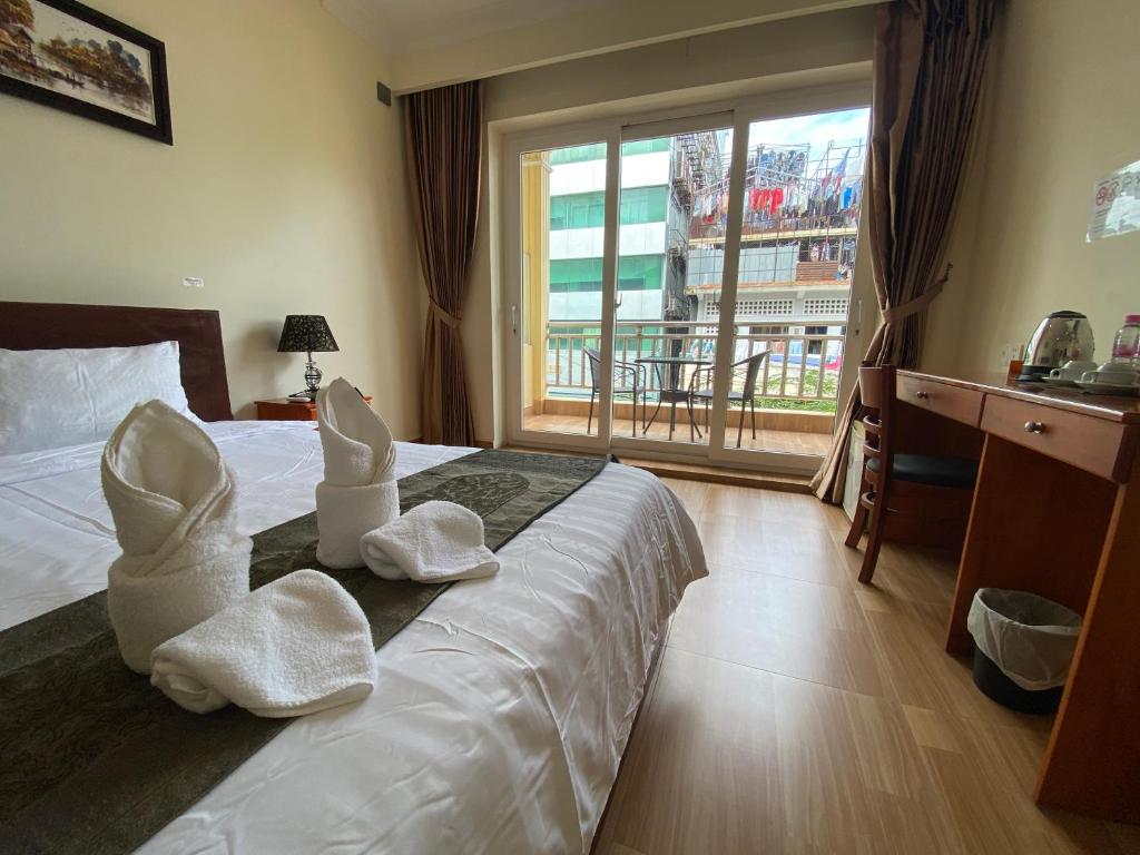 Postel nebo postele na pokoji v ubytování Phnom Penh Le Vincent Hotel