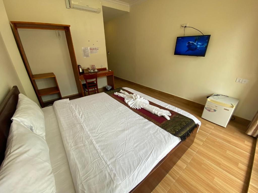 Postel nebo postele na pokoji v ubytování Phnom Penh Le Vincent Hotel