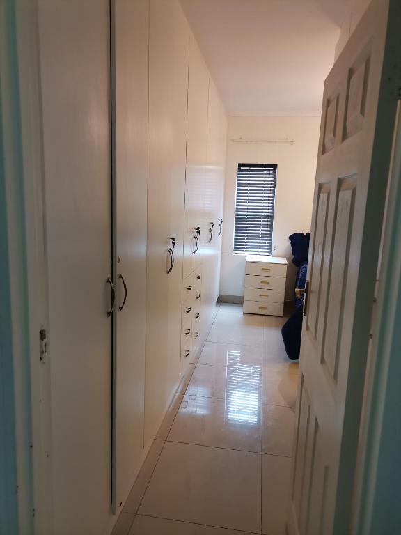 a room with white cabinets and a hallway at QTEN CASINO in Pietermaritzburg