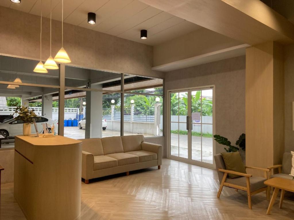 a living room with a couch and a table at Next Bird Suite SHA in Nonthaburi