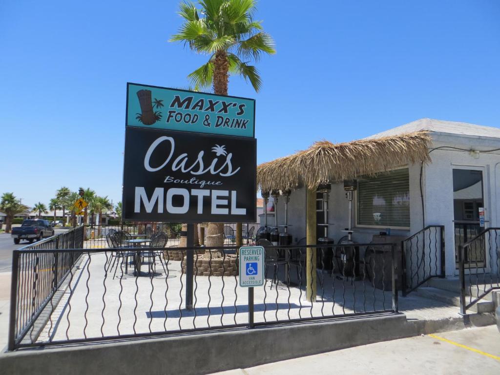 a sign for a restaurant in front of a building at Oasis Boutique Motel in Boulder City