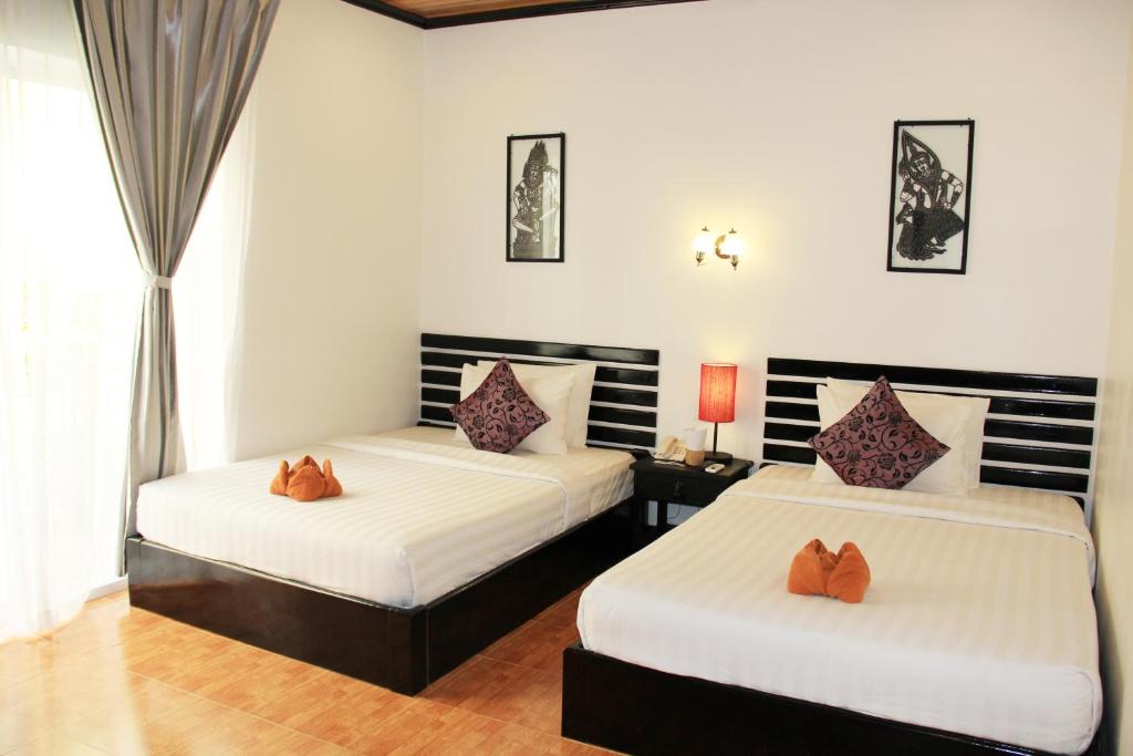 Postel nebo postele na pokoji v ubytování Golden Orchid Angkor