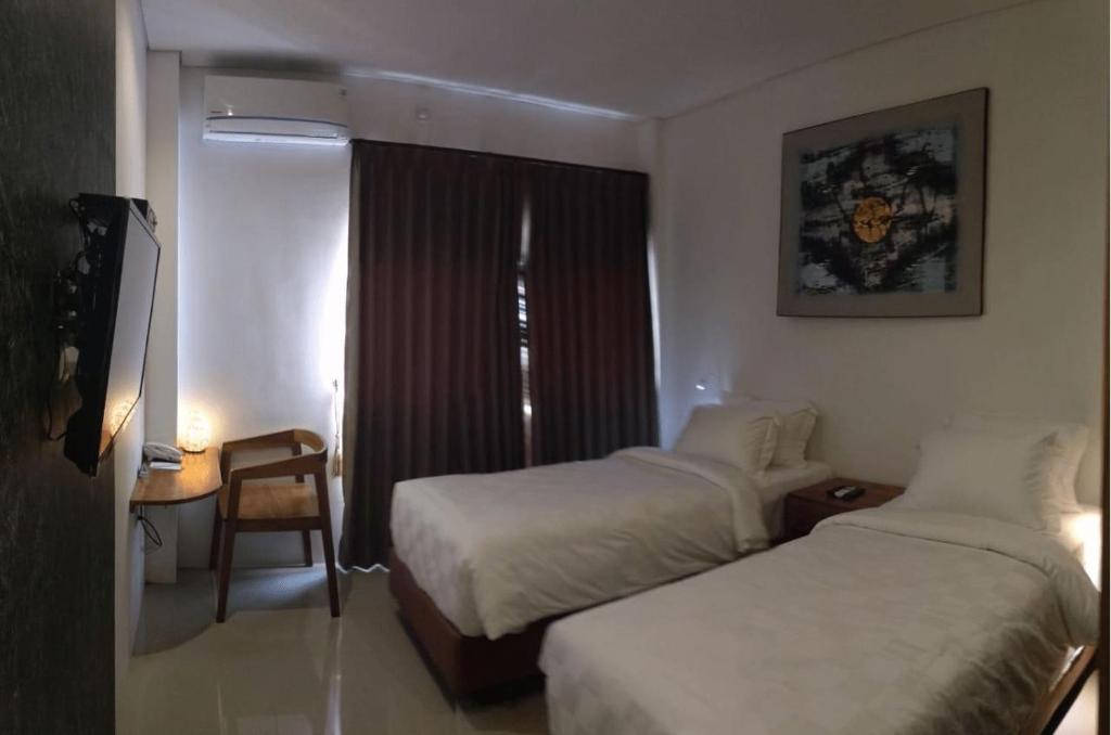 Letto o letti in una camera di Onesouth Boutique Hotel Pulau merah