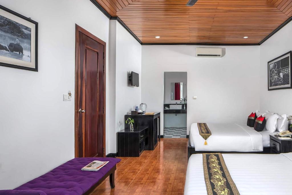 Postel nebo postele na pokoji v ubytování Golden Orchid Angkor