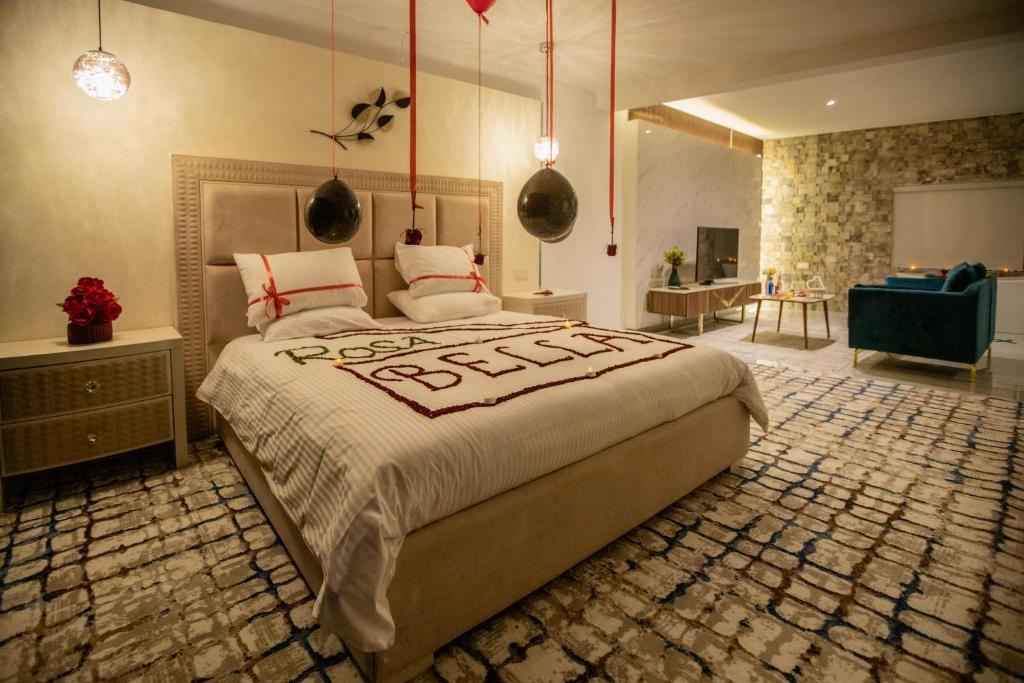 a bedroom with a large bed and a living room at ROSA BELLA in Nizwa