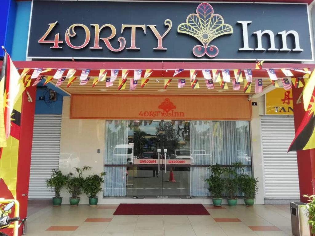 a store front of a store with a sign on it at 4orty Inn in Bintulu