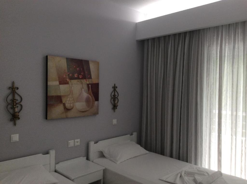 Postel nebo postele na pokoji v ubytování Maria Suites